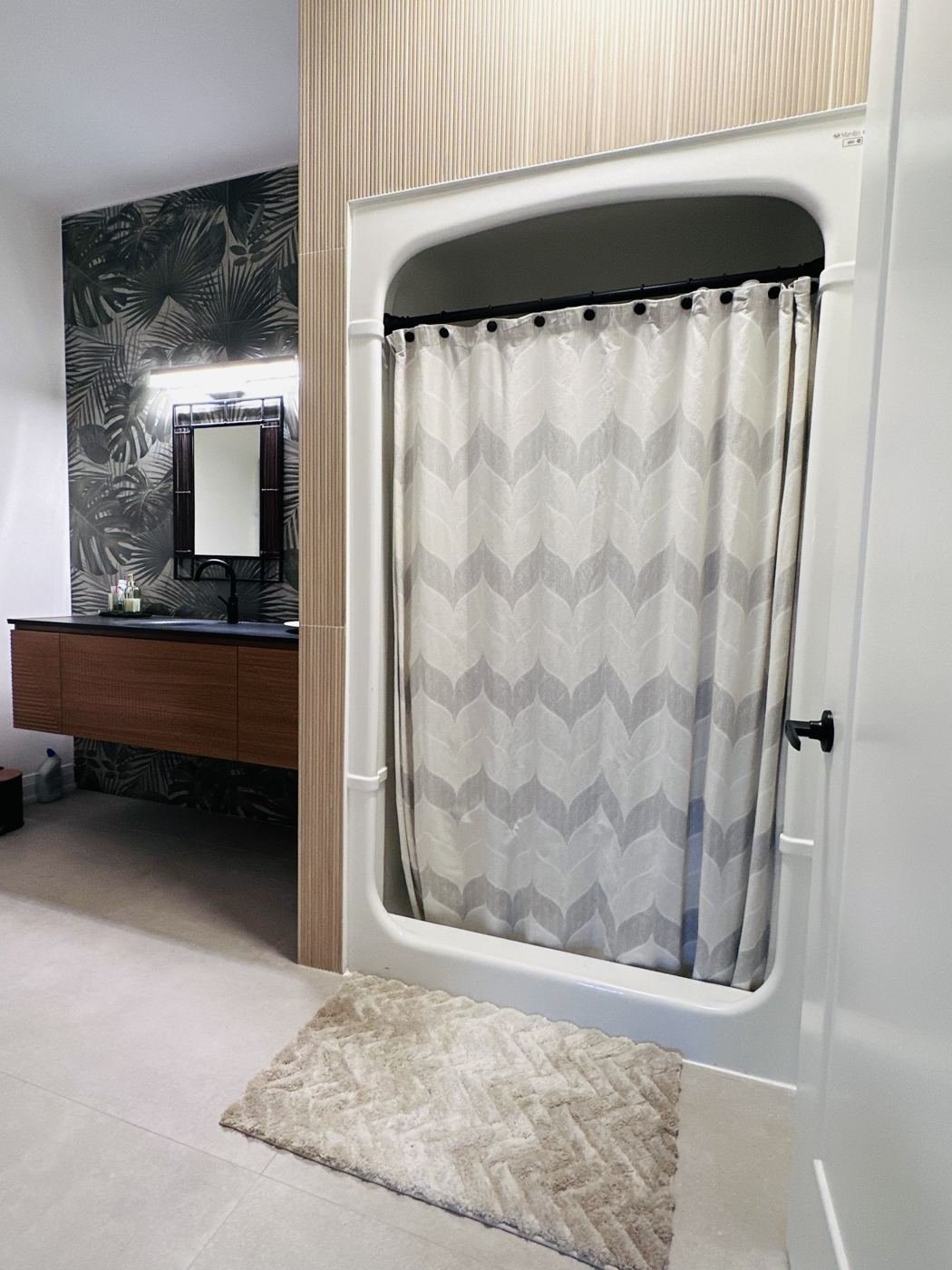 Shower and vanity with wood-panel wall