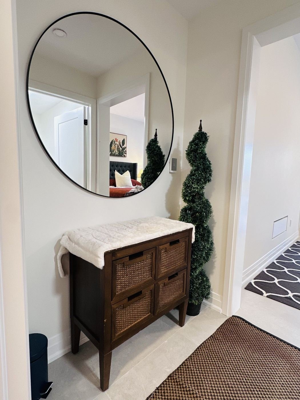 Entry with round mirror and wooden chest