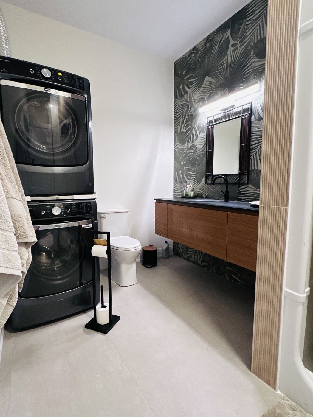 Bathroom with walnut vanity and laundry